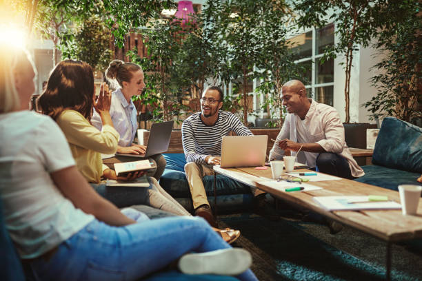 istock Diverse businesspeople working together on sofas in an office lounge 1200974950
