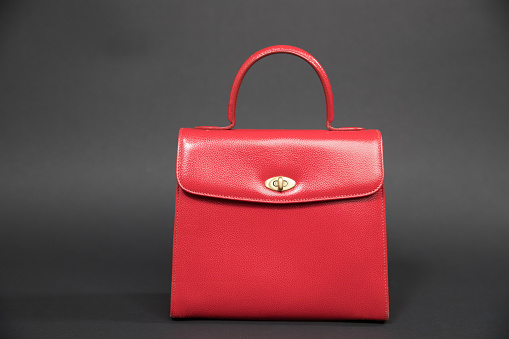 Vintage red women's handbag isolated on black background - Image