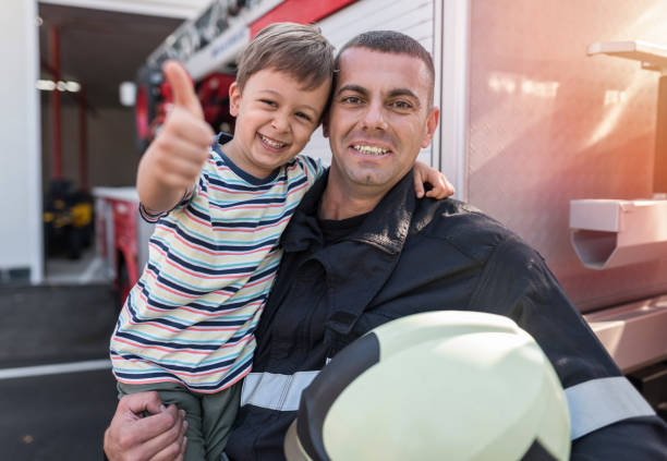 istock Cheerful little boy visiting the firefighters 1200975730