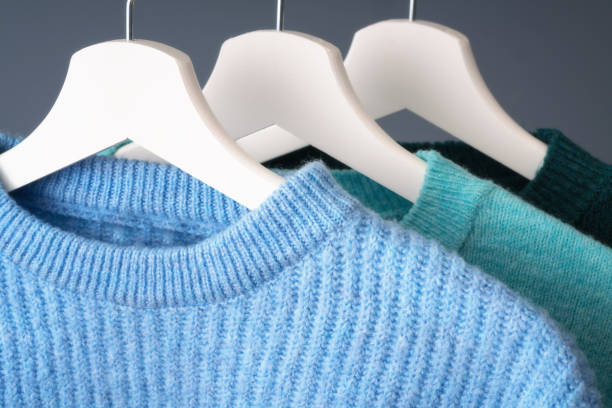 istock Blue color sweaters on a coat hanger 1200975780