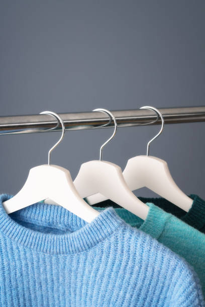 istock Blue color sweaters on a coat hanger 1200975786