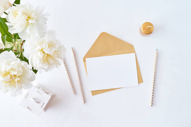 istock Mockup wedding invitation and envelope with white peonies on a white background 1200975800