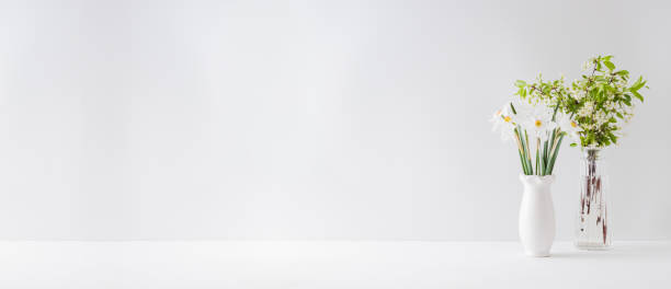istock Home interior with decor elements. Spring flowers in a vase on a light background 1200975801