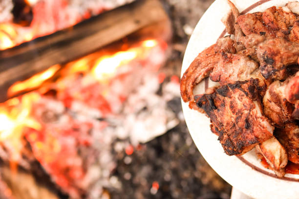 istock Pilaf in the cauldron. Barbecue on a plate. The fire on the nature 1200976359