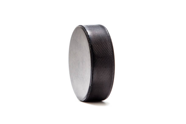 istock Hockey puck isolated on white 1200977320