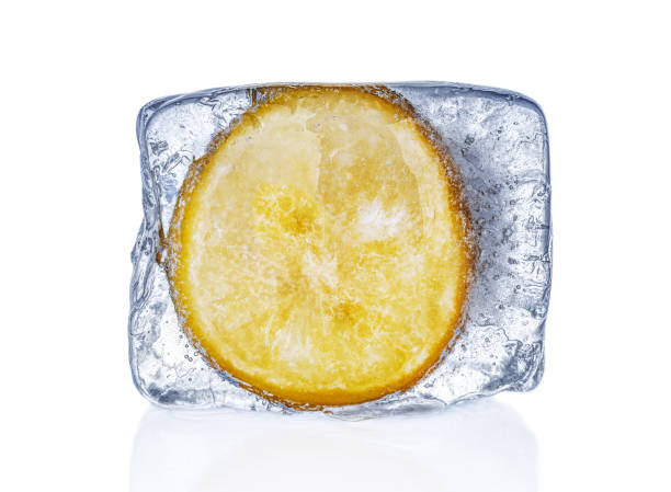 istock Lemon frozen in ice cube on white background 1200977385