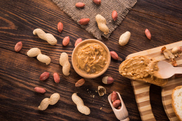 istock Peanut butter in a bowl on a wooden background 1200977798