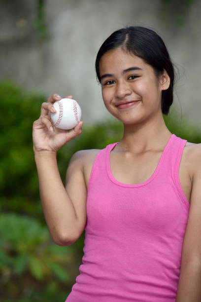 istock Happy Asian Female Athlete With Baseball 1200977906