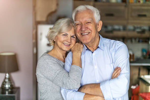 istock Happy senior couple embracing in their home 1200978558