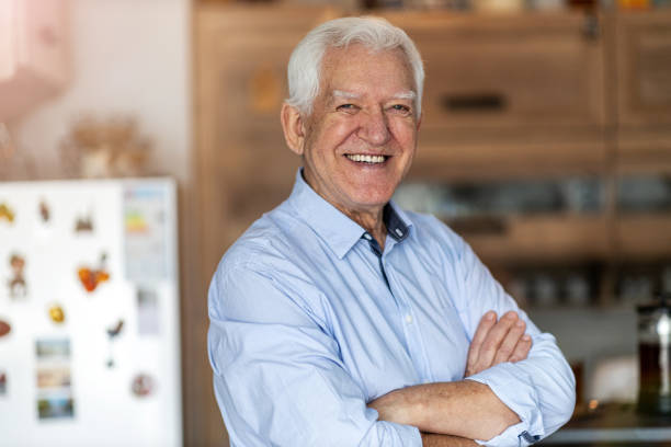 istock Smiling senior man in his home 1200978562