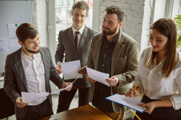 istock Group of young business professionals having a meeting, creative office 1200978666