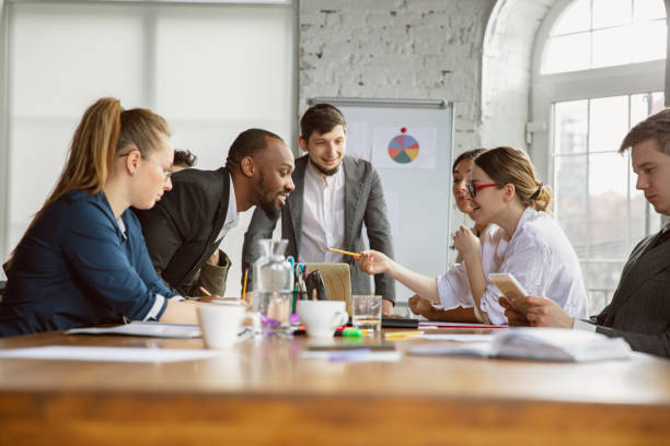 istock Group of young business professionals having a meeting, creative office 1200978691