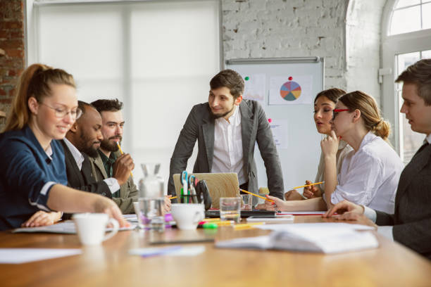 istock Group of young business professionals having a meeting, creative office 1200978697