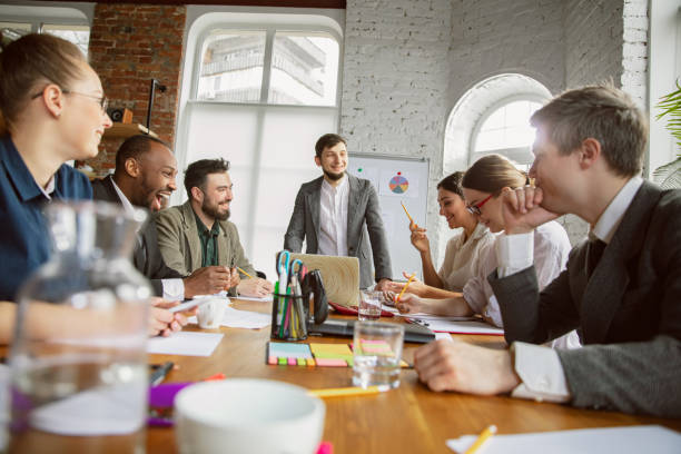 istock Group of young business professionals having a meeting, creative office 1200978708