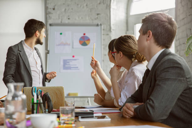istock Group of young business professionals having a meeting, creative office 1200978711