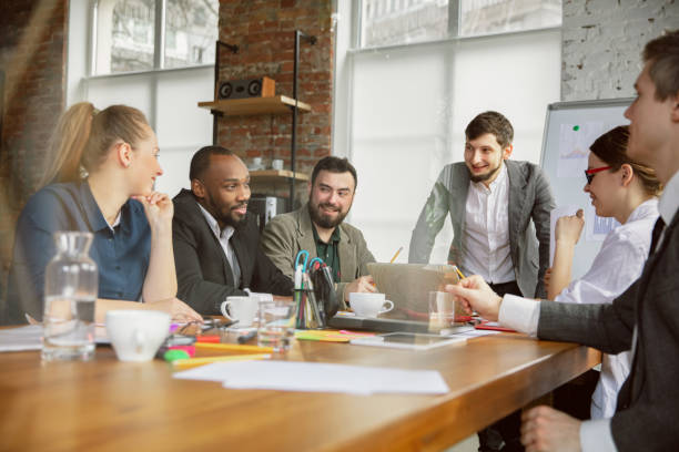 istock Group of young business professionals having a meeting, creative office 1200978719