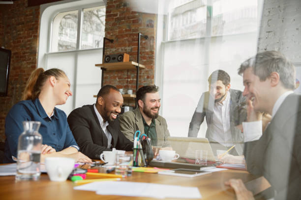 istock Group of young business professionals having a meeting, creative office 1200978728