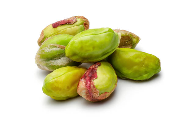 istock Heap of peeled pistachio nuts isolated 1200978786