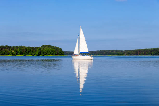 Vacation in Poland - sailboat on the Niegocin lake, Masuria Vacation in Poland - sailboat on the Niegocin lake, Masuria sailboat stock pictures, royalty-free photos & images