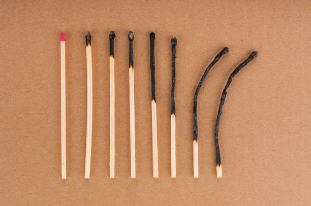 istock Row of different burnt matches on brown background 1200980590