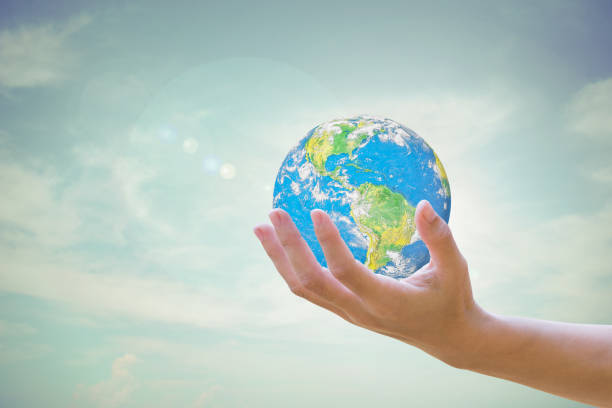 istock World Human hands the sky in the background blurred 1200981070