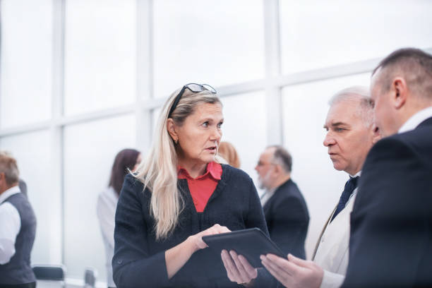 istock serious employees discussing business document before meeting. 1200983017