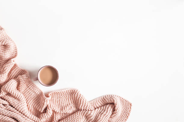 istock Cup of coffee, pink blanket on white background. Flat lay, top view, copy space 1200983695