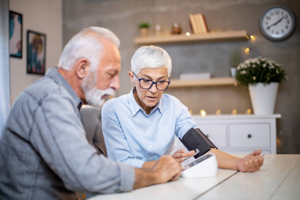 istock Senior couple checking their blood pressure. 1200983961