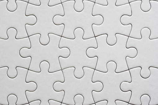White puzzle pieces comes together on blue background