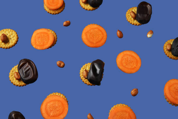 istock Healthy snacks pattern – cookies, dates, raw carrots and peanuts 1200985547