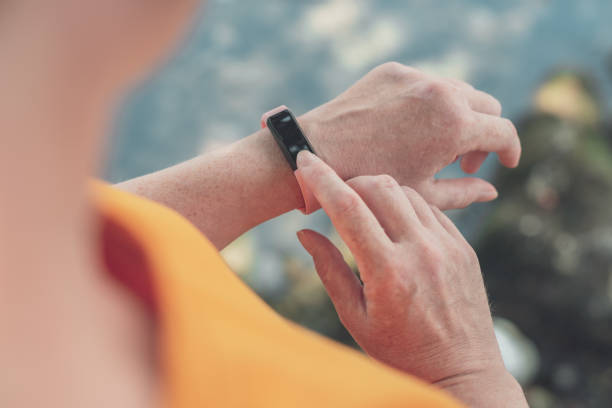 istock Woman hiker using smart bracelet during trekking in nature 1200985786
