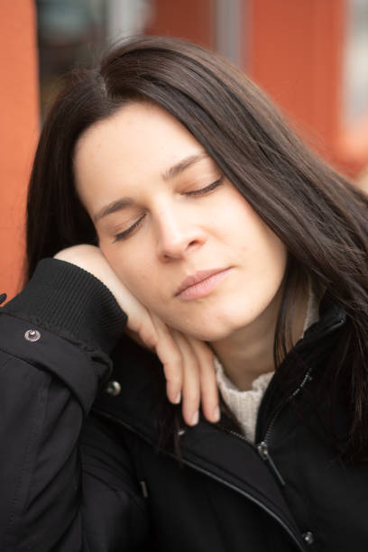 istock Brunette woman with closed eyes 1200987236