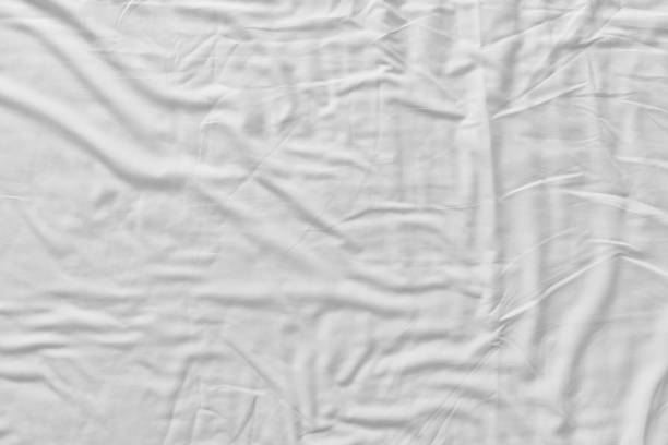 istock Top view of bedding sheets crease,white fabric wrinkled texture 1200988219