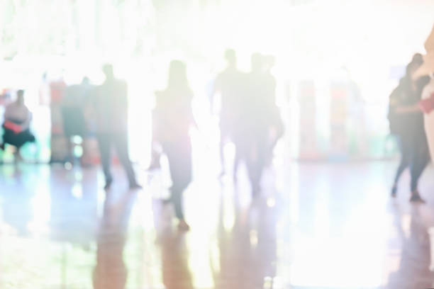 istock Abstract blurred corridor with people walk Background From Building Hallway for corridor building background 1200988287