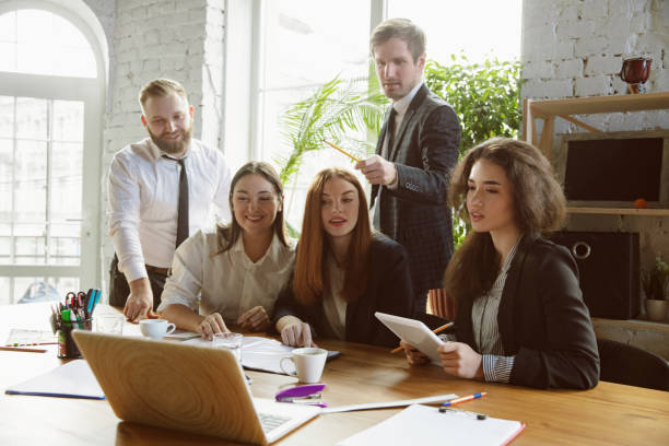 istock Group of young business professionals having a meeting, creative office 1200989123