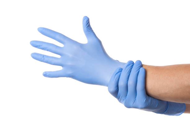 istock Doctor putting on protective gloves, isolated on white 1200989832