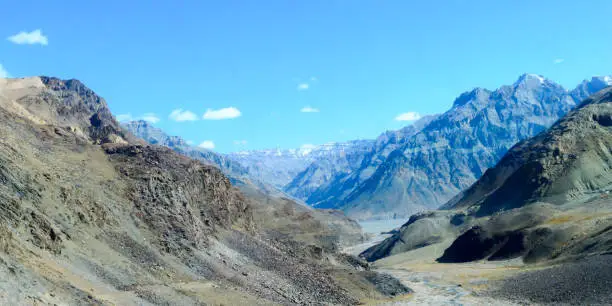 Photo of V-shaped spur hill ridges of Pirin mountains valley. A zig zagging fluvial valley that interlock or overlap in a staggered manner. V-shaped valley that extends into a concave bend from opposite side.