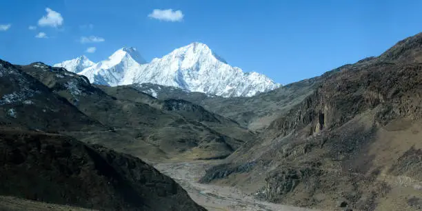 Photo of V-shaped spur hill ridges of Pirin mountains valley. A zig zagging fluvial valley that interlock or overlap in a staggered manner. V-shaped valley that extends into a concave bend from opposite side.