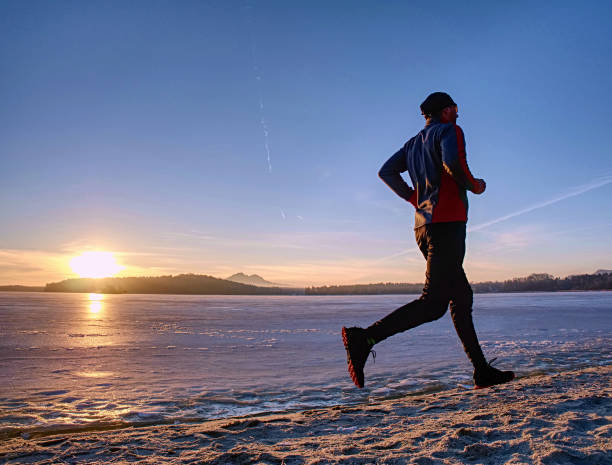 istock Running or jogging on beach in winter, sunny day morning 1200993800