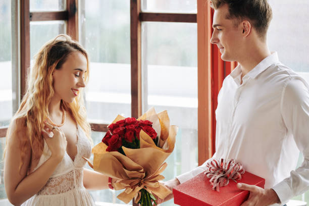 istock Woman Accepting Flowers And Chocolate 1200994960