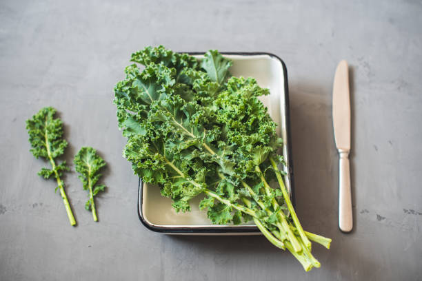 istock Green Organic healthy fresh Kale or leaf cabbage in a white enameled container 1200995124