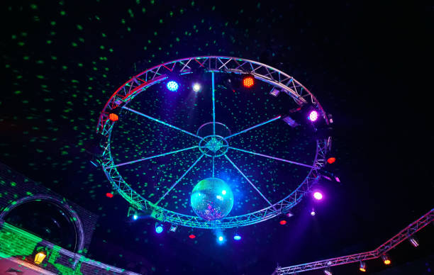 istock The disco ball with light rays in night club. Party background. 1200995452