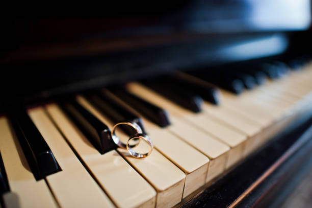 istock Wedding day. Accesories for wedding preparation. Wedding rings in piano. 1200996176