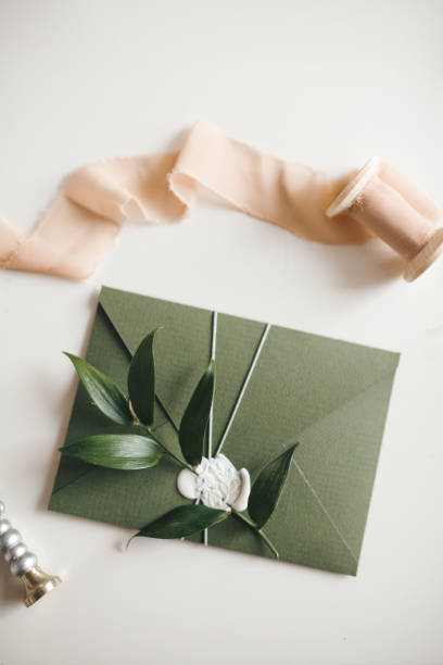 istock Green modern recycled paper wedding invitation on white background 1200996614