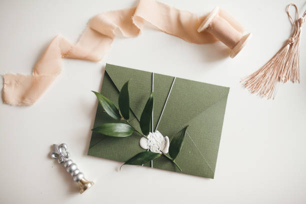 istock Green modern recycled paper wedding invitation on white background 1200996679