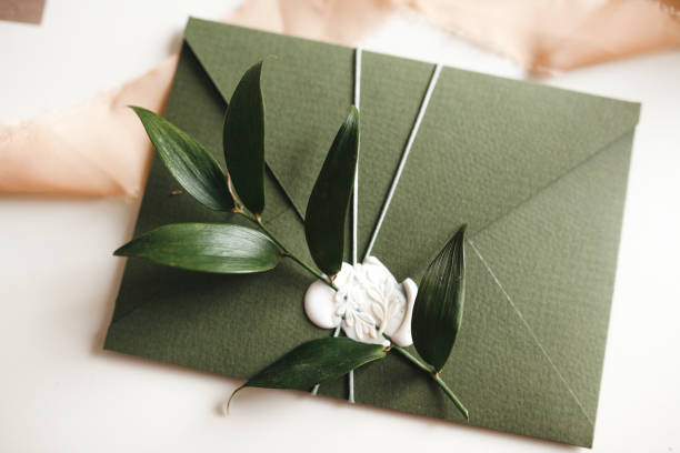 istock Green modern recycled paper wedding invitation on white background 1200996691