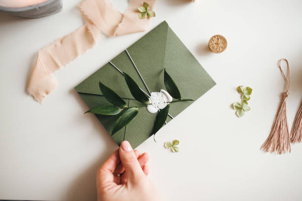 istock Green modern recycled paper wedding invitation on white background 1200996701