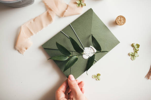 istock Green modern recycled paper wedding invitation on white background 1200996733