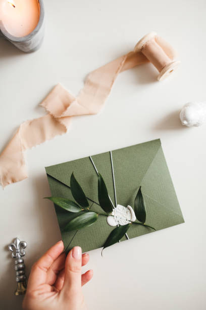 istock Green modern recycled paper wedding invitation on white background 1200996797