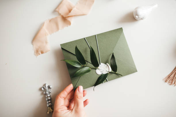 istock Green modern recycled paper wedding invitation on white background 1200997376